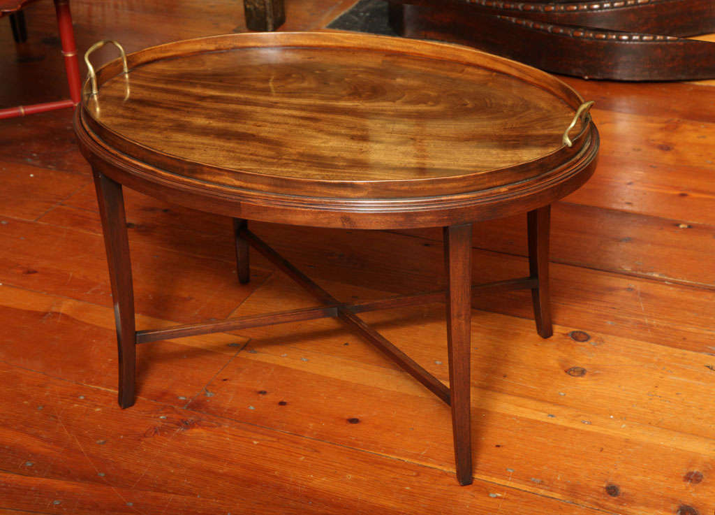 Very fine George III large oval flame grain mahogany tray with conforming solid gallery and the original shaped brass handles, on custom made stand of later date.  English c.1780