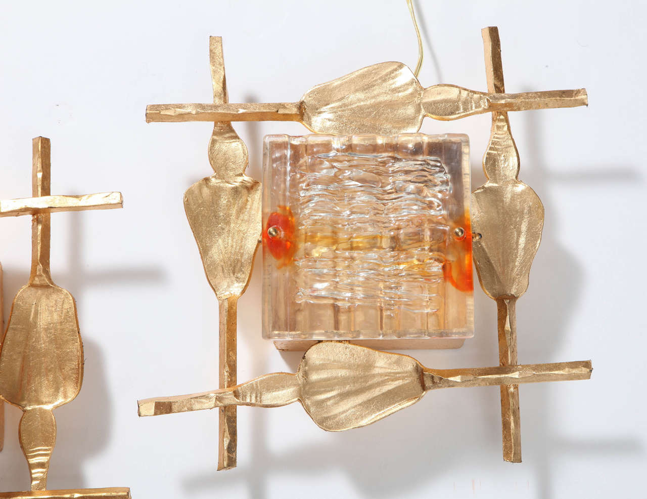 Decorative pair of sconces, Sweden, circa 1960. Gold leave metal with a lucite cover.