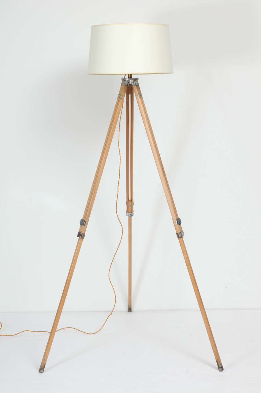Vintage tripod floor lamp.  USA, circa 1950.  Blond wood adjustable height legs with brushed metal joints.  Newly rewired with custom shade.  Tallest height is 68 inches; may be manually adjusted to a lower height.