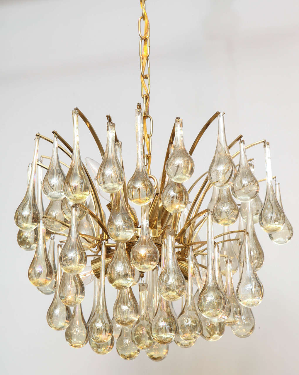 Mid Century classic chandelier made from champagne color Murano glass tear drop elements suspended from a gilt washed brass. Chandelier body measures 16