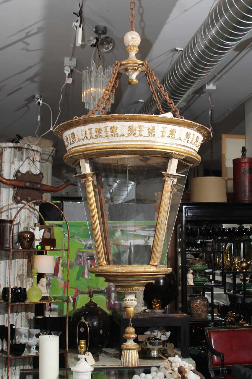 Fabulous oversize Italian 6 ft tall lantern in gilt and worn white.
Large candle pricket, but could be easily electrified if you chose to. Grand scale and lovely patina, impressive in person. Good indoors or outside in protected area. Glass panels