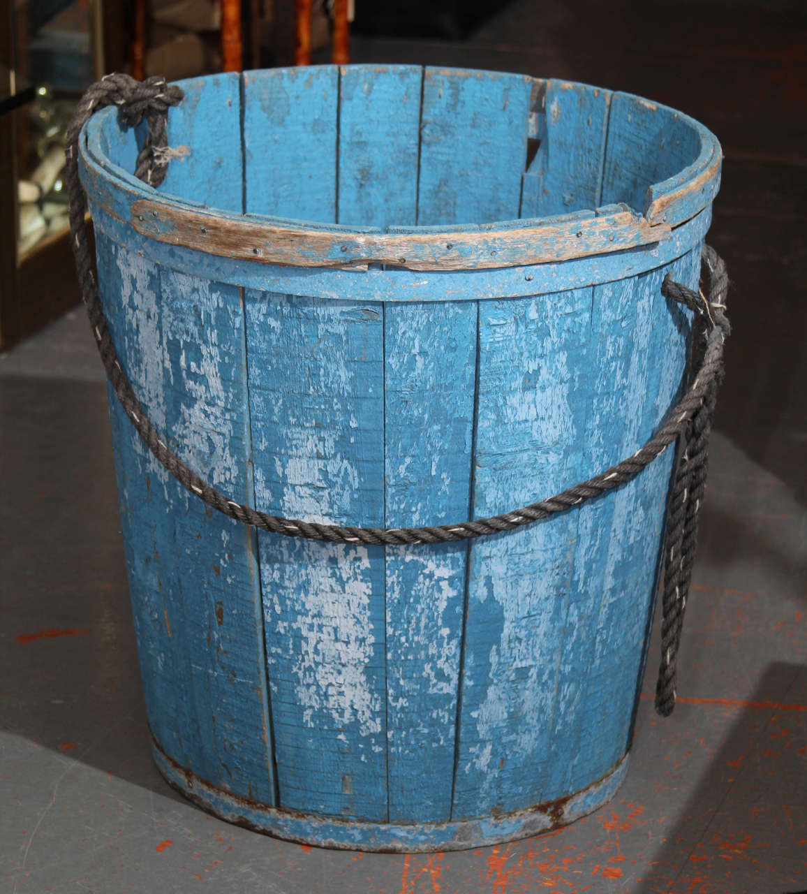 Great old blue paint on large container of wood with metal banding. Would be perfect poolside to hold towels or lemon tree - or indoors as a lovely object /for firewood /or as a catch- all.