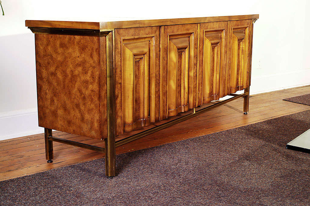 Mastercraft Furn Co burled carpanthian elm cabinet with brass stretchers and side mounts. Four carved doors and inset travertine marble tops add to the quality of this piece.