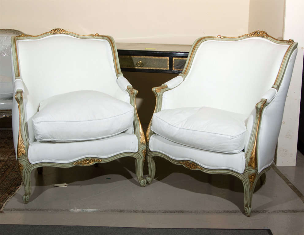 Pair of elegant bergere chairs in the style of Louis XV, green painted and parcel-gilt frame with new upholstery. Stamped Jansen.