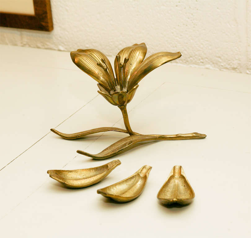 This is a great brass lotus flower that dismantles to individual petal ashtrays. <br />
A great sculptural piece on it's own.