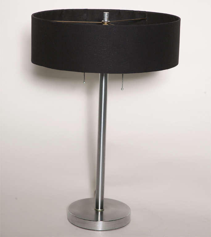 This pair of lamps is all dressed up and they do have someplace to go: bedside. Their bases are 1-inch brushed steel disks, diameter 7.5 inches. Risers are 1-inch diameter brushed steel posts, culminating in S-curve double-socket fixtures. Shades