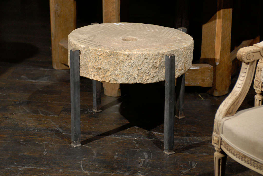 A grinding stone from a mill with a custom made base.