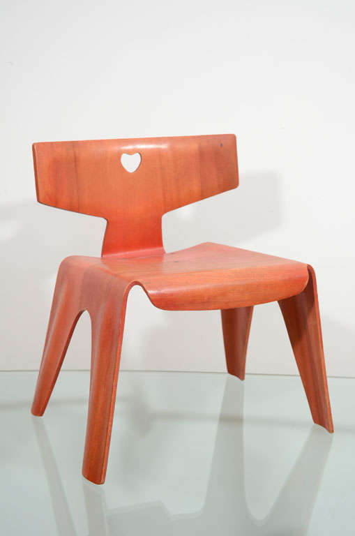 First produced chair by Eames this is an original molded plywood child's chair in red aniline dye. Very minor wear. Made by Evans Products.