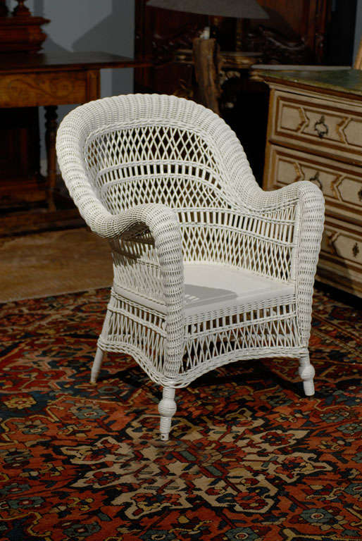 A wonderful wicker chair with arched back.