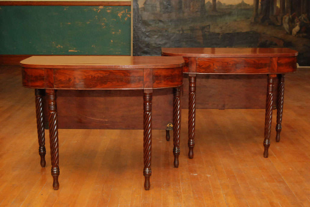 This classical pair of Boston tables usable either as consoles or as a dinning table show many fine feature associated with the best of this form. The fine turned ring design at the top and bottom of the legs combined with the twisted carving of the