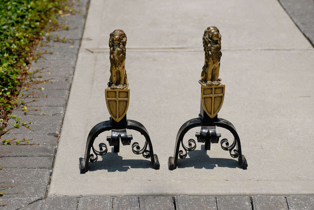 Beautiful quality pair of c.1900 English cast bronze and iron lion andirons with crest.
