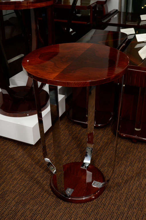 A single burl walnut art deco lamp table with chrome supports in the style of Donald Deskey.