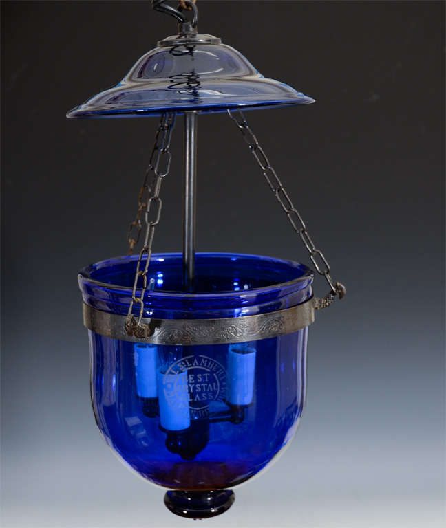 Bell lantern light fixture by Val St. Lambert in deep blue glass with a scrolling floral motif etched into the metal details. Pre World War I, turn of the century fixture.<br />
<br />
Reduced From: $950