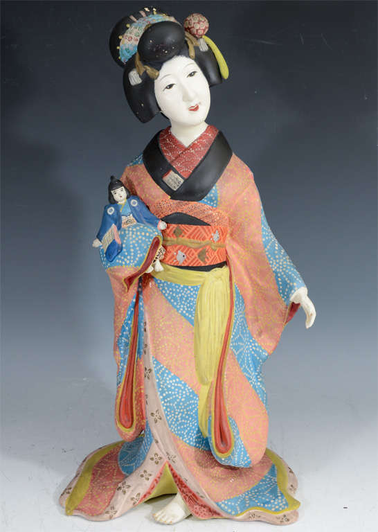 A figure of a geisha in oyster shell lacquer with intricately detailed painted robes. The piece is signed on the bottom and a similar example is in the collection of the Peabody Essex Museum in Salem, Massachusetts.

10203