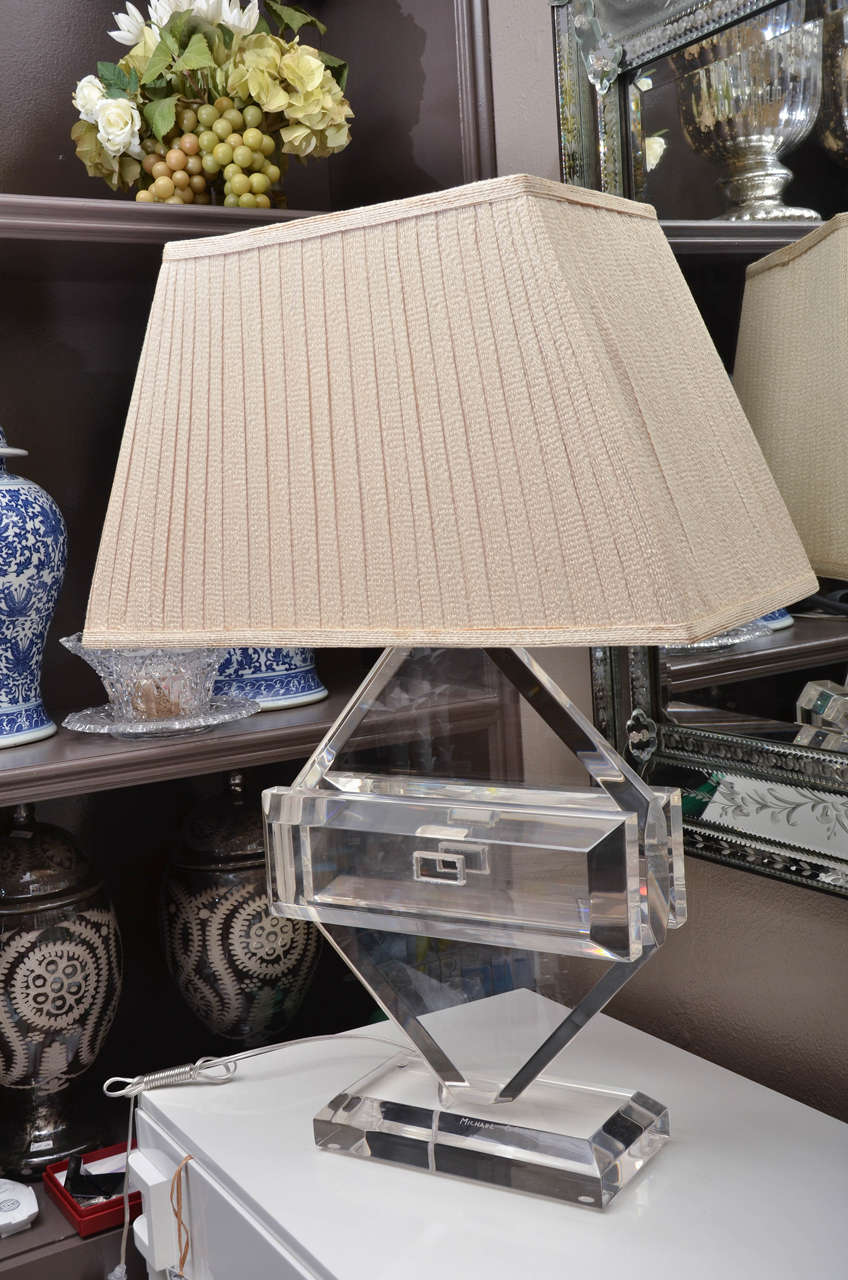 Fabulous vintage Lucite table by Michael Oguns. The lamp is signed Michael Oguns. It has the original custom shade.