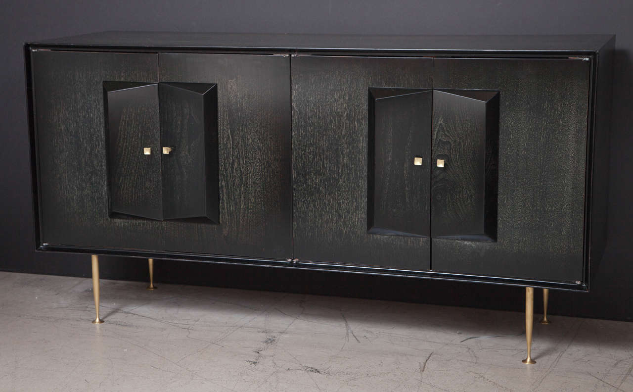 1950s Italian sideboard with an striking and unusual ebonized and cerused finish on highly figured mahogany. Four doors reveal two interior compartments, one with an adjustable shelf, the other with an interior drawer and an adjustable shelf.