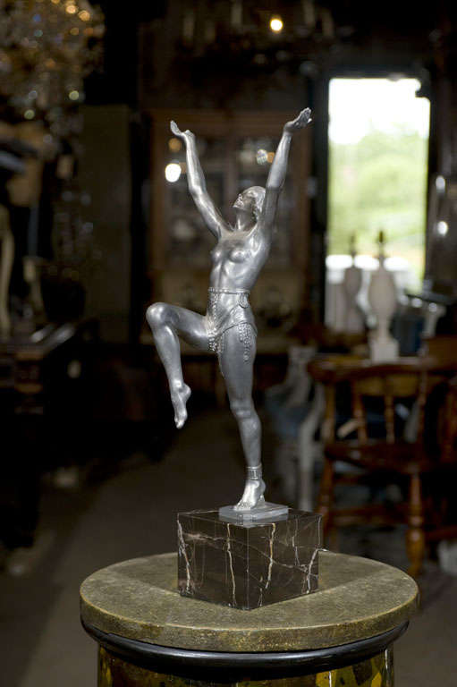 Zinc female figure of a dancer mounted on marble base. Signed 