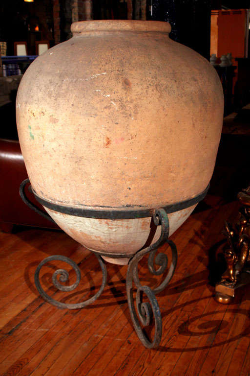 Clay wine vessel from a Jesuit monastery. Has Jesuit symbols. Vessel is 19th century, stand is newer.