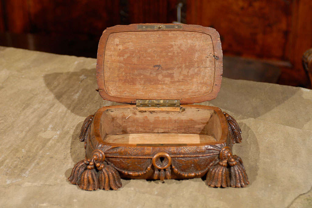 Carved Black Forest box with dog and tassles.