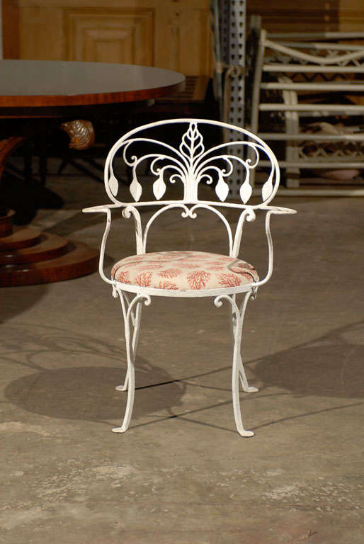 Pair of Early 20th century American painted iron garden armchairs.