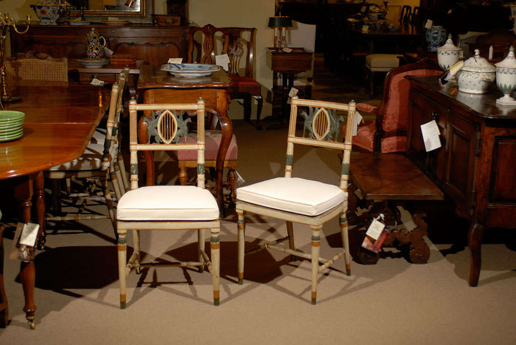 Pair of 19th Century Italian polychrome painted Chairs with sphinx detail on back splats, caned seats with cushions and tapered legs with stretchers.  

4 PAIRS AVAILABLE.