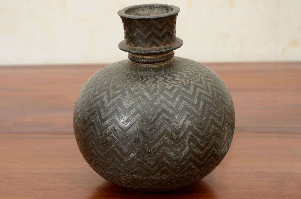 This fine Indian Bidriware vase, formerly a hookah pot, has a globular body decorated with a chevron pattern. Bidriware originated in Bidar, India in the fourteenth century, when an artisan from Iran, Abdullah bin Kaiser, was invited by the Bahamani