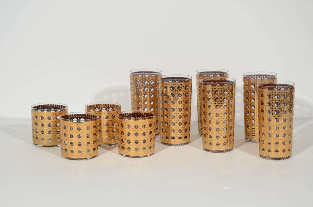 Sexy barware glasses with stylized rattan details in <br />
a gold leaf finish.  Set includes six highball glasses<br />
and four rock glasses.  Rock glasses measure <br />
3.25
