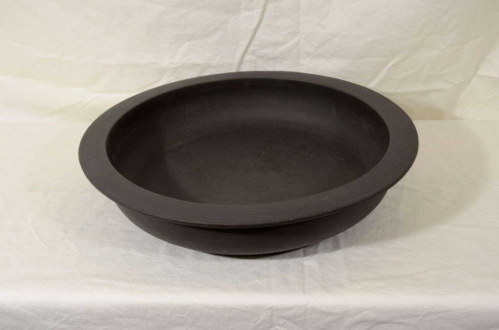 A Wedgwood Black Basalt bowl in a rare low open form with everted lip. Made in England circa 1880.
 Black Basalt was created by Josiah Wedgwood in the 18th century. Wedgwood transformed Egyptian Black, a traditional Staffordshire stoneware, into