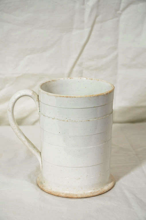 An elegant English Creamware tankard sculpted with 7 broad horizontal bands