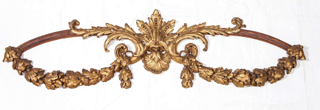 Pair antique gilt and wood decorative wall elements composed of acorns and oak leaves, center shells, leaves and beading.  Could be used effectively  above a bed or any walls.