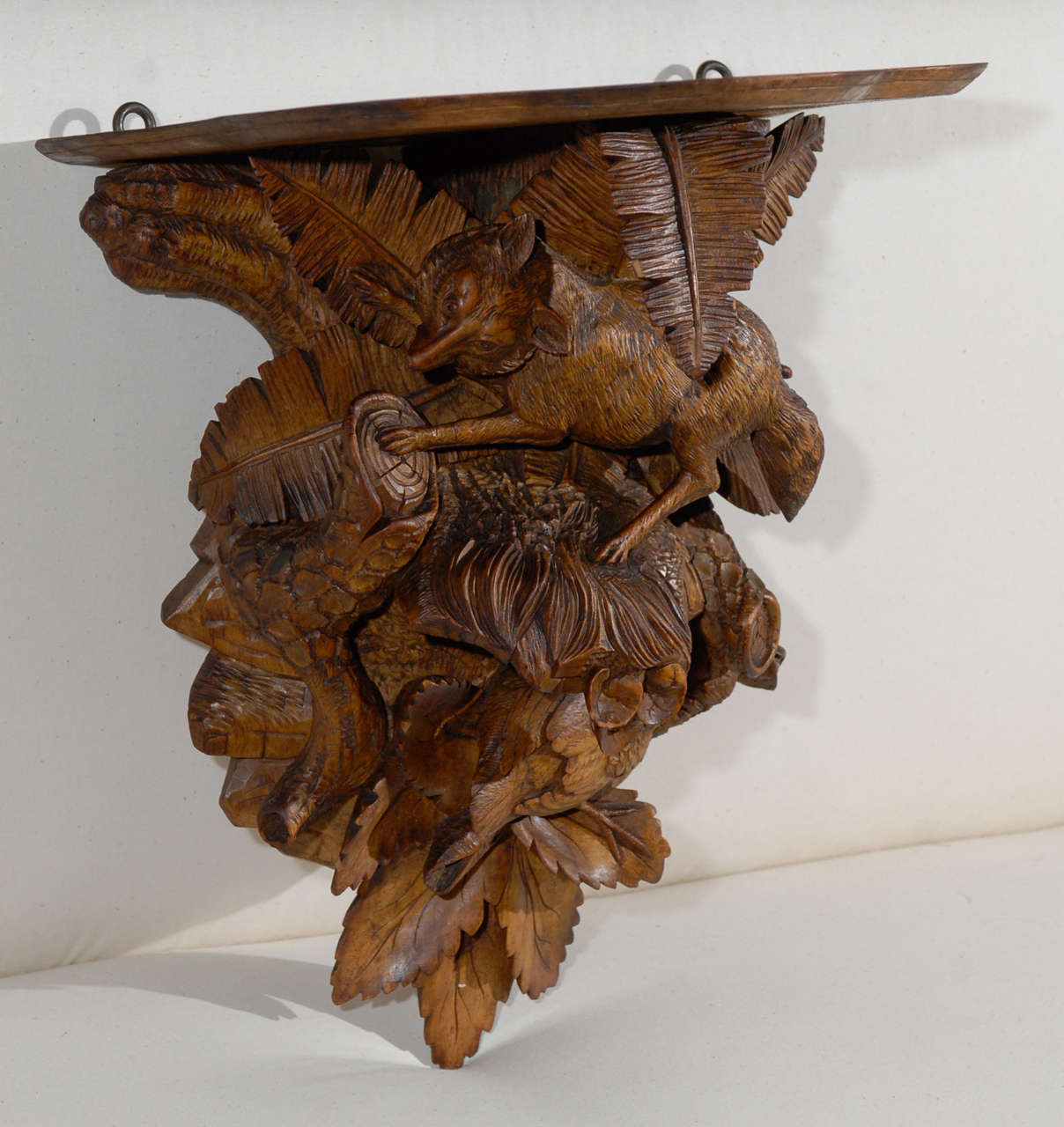 Carved wall bracket with a fox and bird.