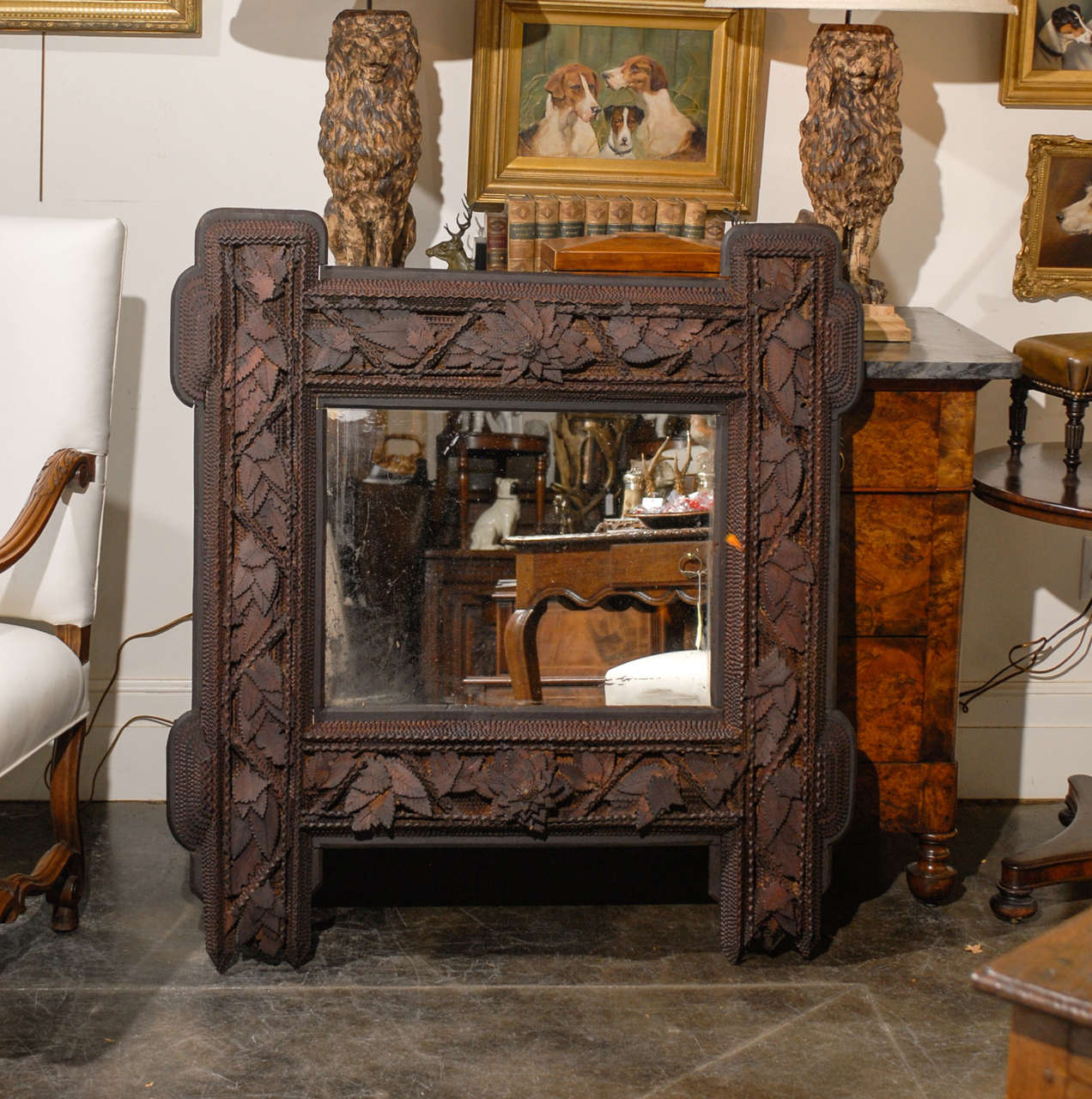 Large carved tramp art mirror with carved leaves.
