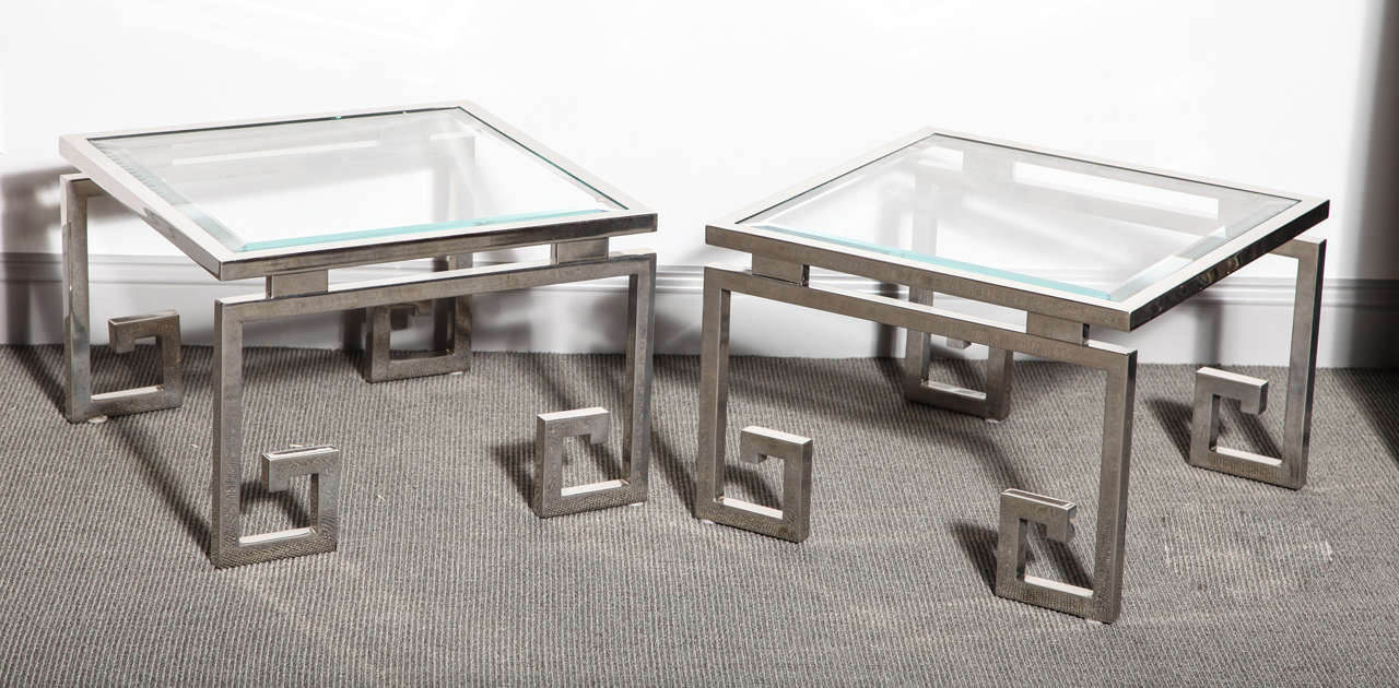 Metal base tables in polished chrome finish with an Asian inspired design, and a beveled glass top. They were made for a Gucci showroom in Paris during the 1980s.