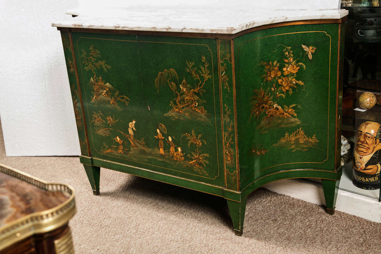 Spectacular French Directoire style sideboard, possibly 2nd quarter of 20th century, the grey veined white marble atop a conforming cabinet that is painted green with raised Chinoiserie playground scene, two center doors open to shelving interior,