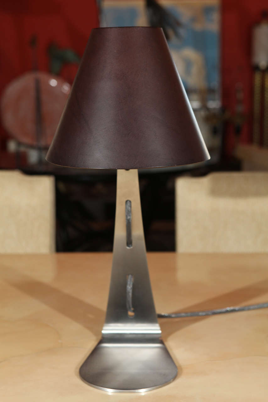 Leather shaded steel table or desk lamp. The shade is available in hand-sewn leather with stitching and also available in Murano glass, see last two images.  LED technology.