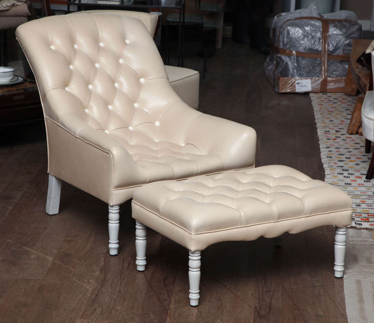 Tufted scoop lounge chair & ottoman upholstered in bone leather with hair-on-hide covered buttons and whitewashed turned legs circa 1960
Chair: 28.5