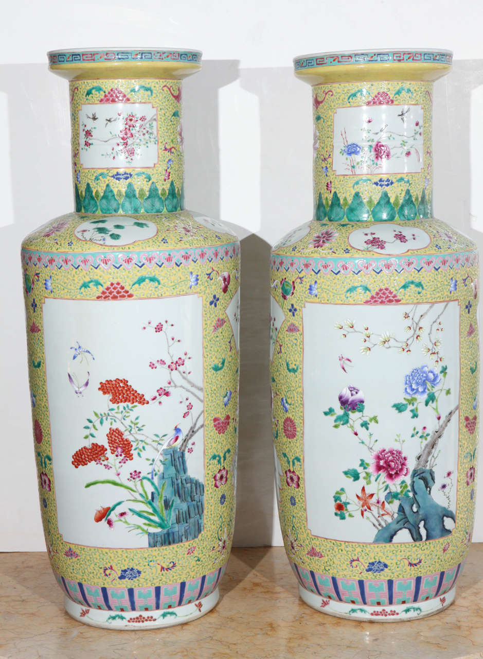 Pair of large and colorful, 1920s, Chinese, long-necked urns with tapered bases.