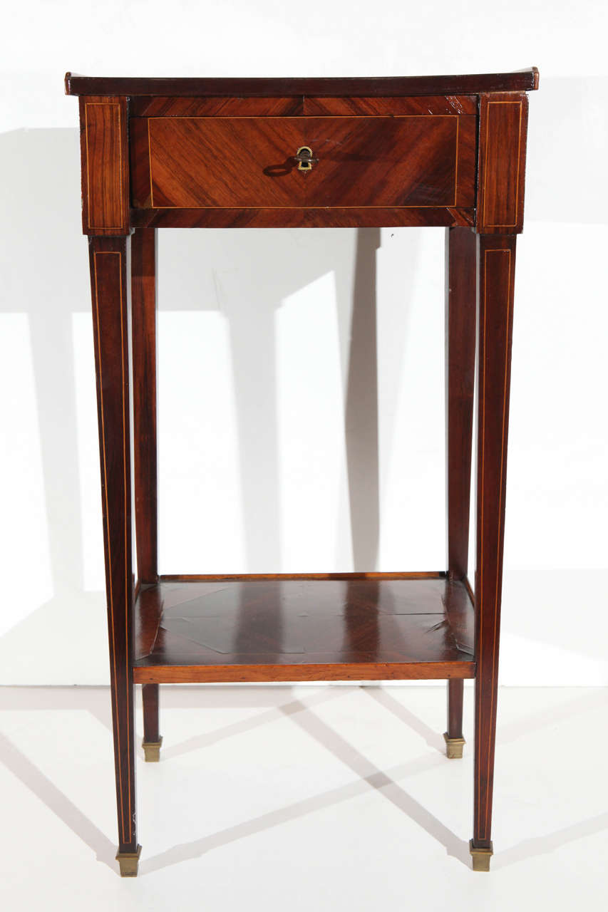 Elegant, veneered, single drawer side. Marquetry table on tapered legs with ormolu feet.