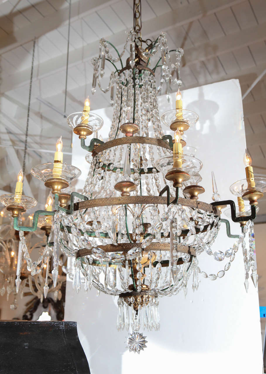 Multi-tiered, neoclassical, twelve-light  Italian crystal chandelier.