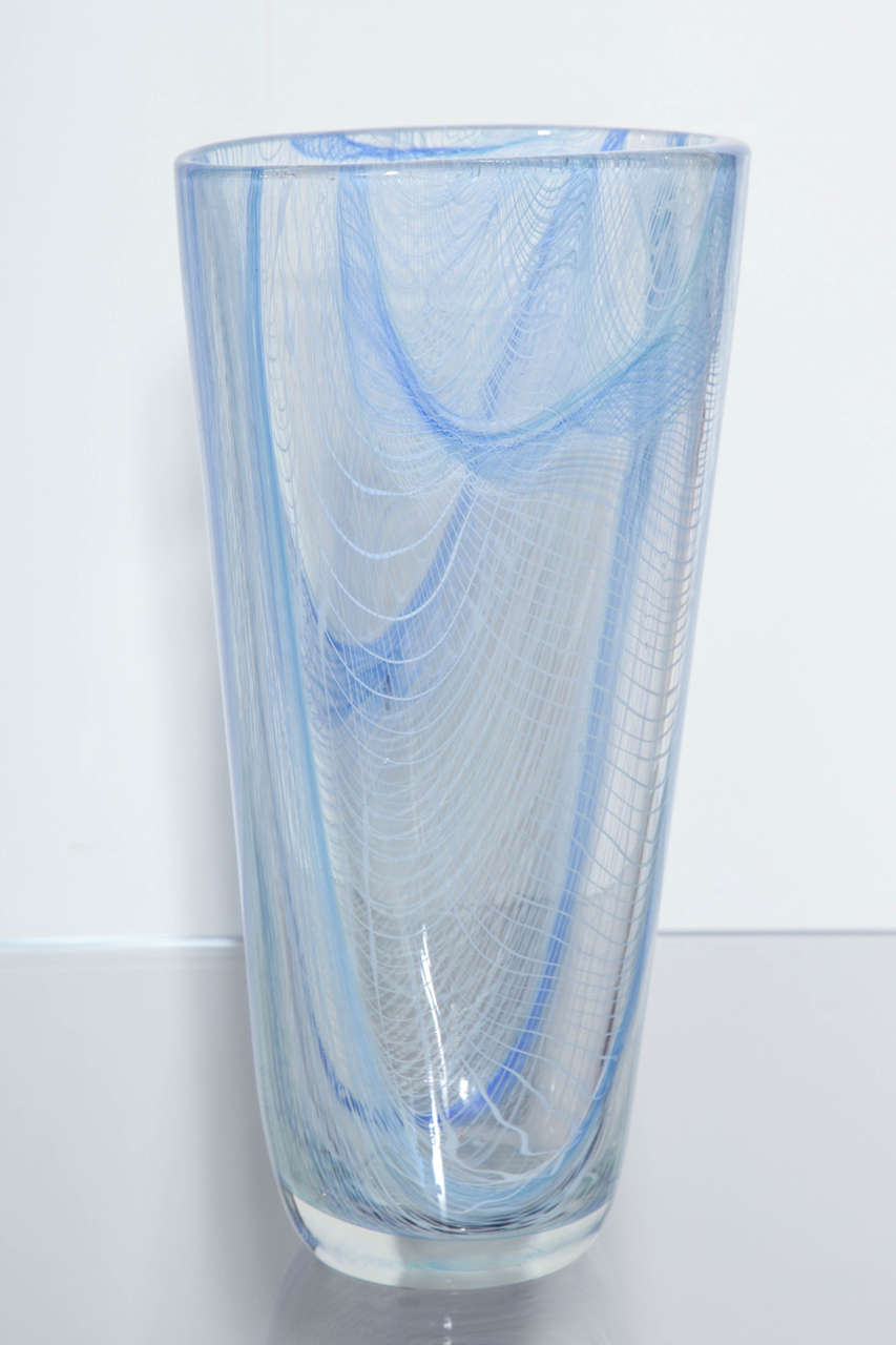 Large scale "Merletto" glass vase by Romano Dona. Gorgeous vase of clear glass with intricately woven canes infused into the glass to create a netting effect. Swirling lines of white and shades of blue imbedded into the glass give a dreamy