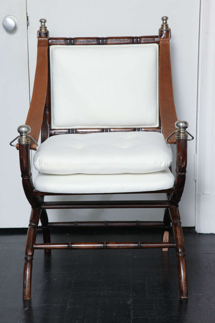 Midcentury rosewood sling chair, leather straps, Curule legs joined by cross stretcher.