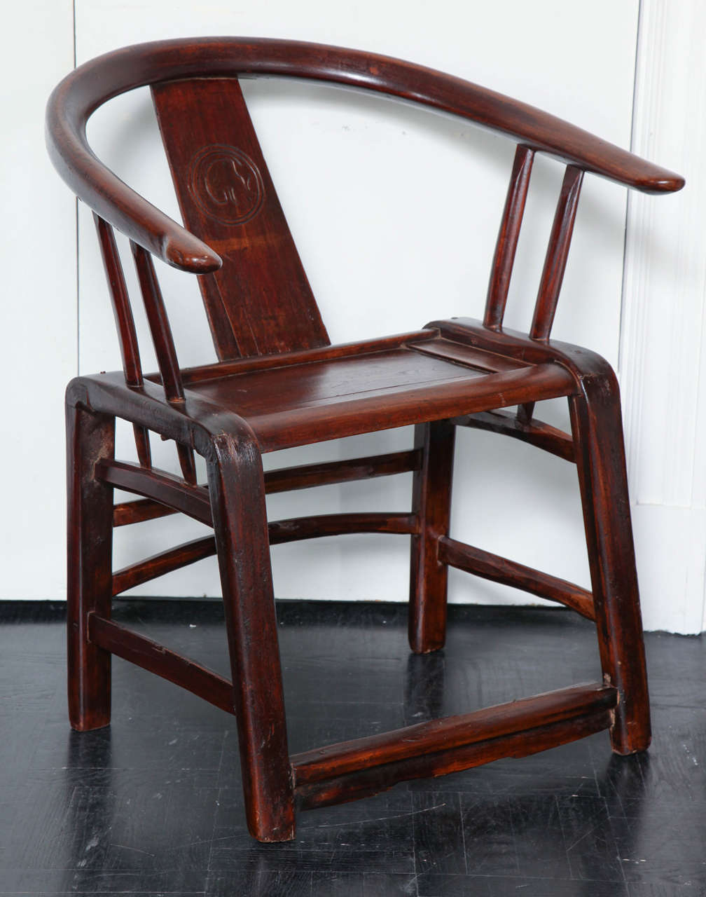 19th century elmwood armchair, horsehoe-shaped back, centre splat, straight legs joined by stretchers.