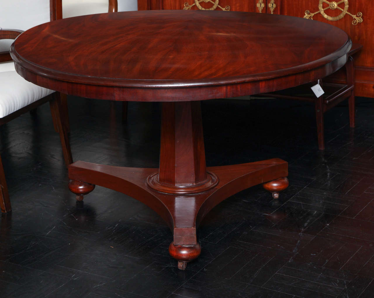 Early 19th century mahogany pedestal table, tripod base, bun feet.