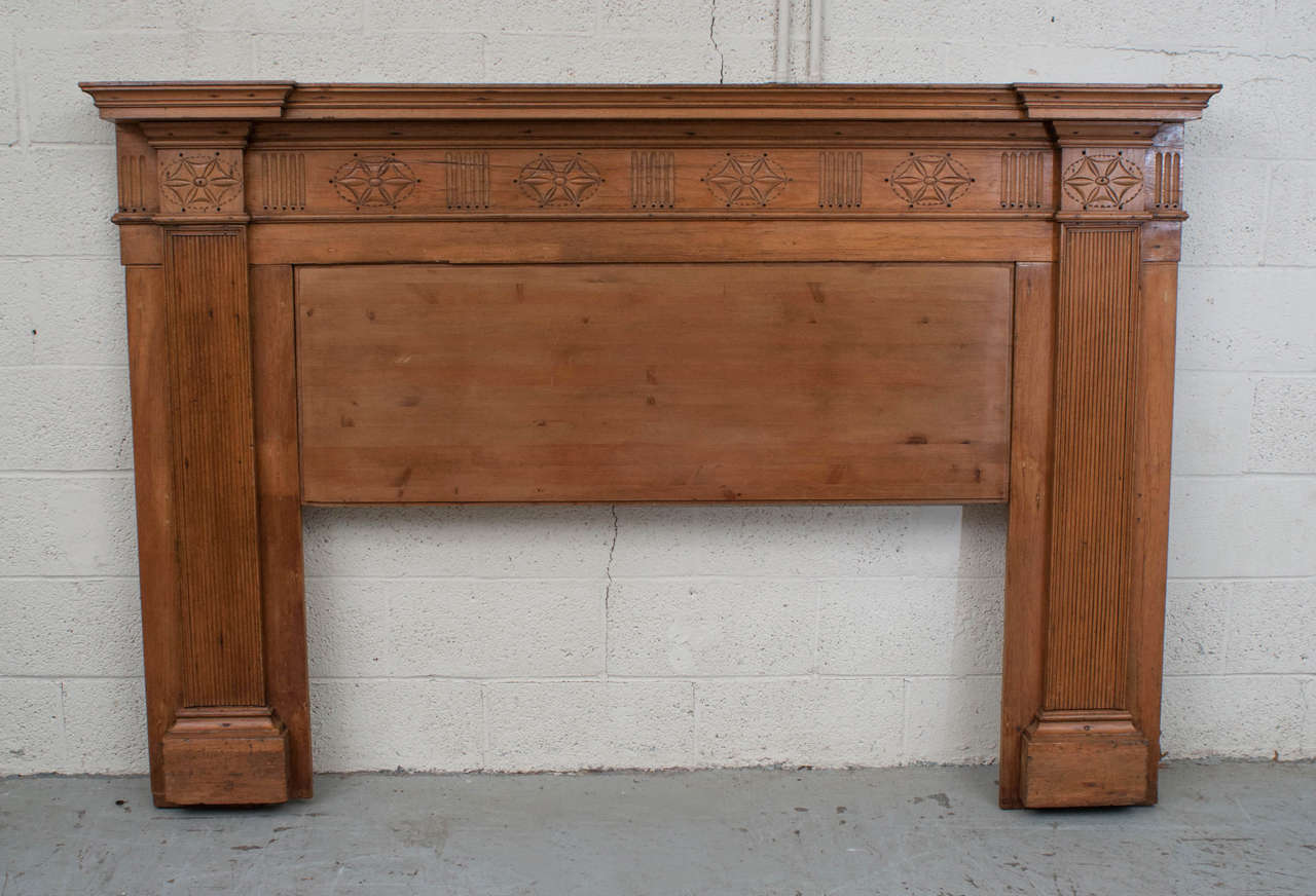 A genuine Federal period pine fire surround bearing reeding, fluting, piercing and carvings typical of the time. This piece is almost entirely original with some very minor reinforcement to the back. The opening is a generous 50