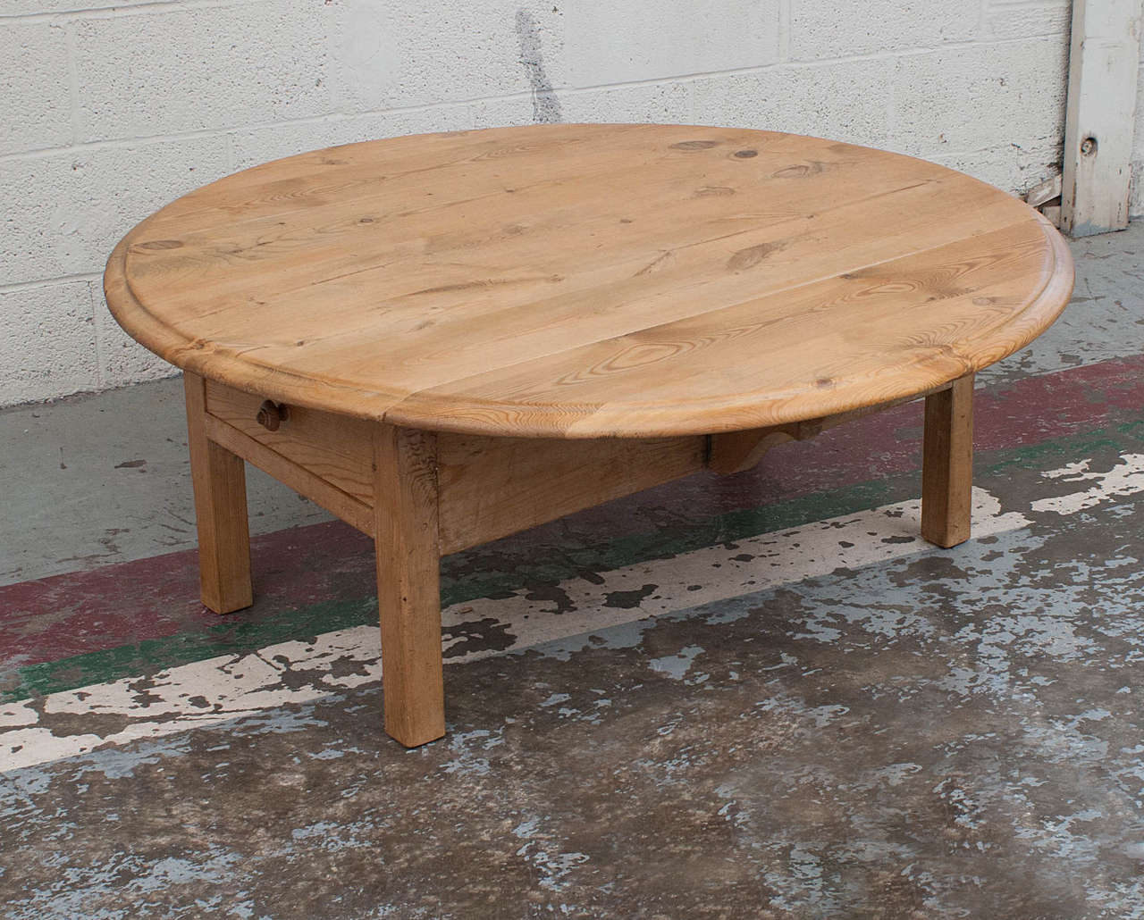 A pine drop-leaf table cut down to coffee table height featuring straight legs, a softly routed edge to the top, and a deep dovetailed drawer at each end. The butterfly supports beneath the leaves allow this versatile table to be used in three