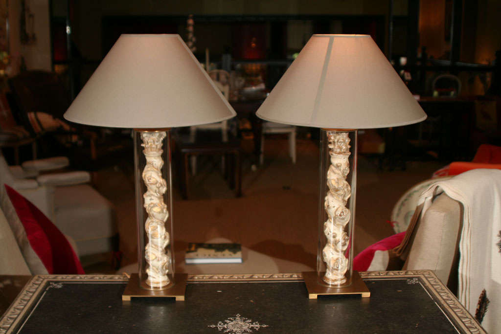 A pair of continental giltwood columns later encased in glass and mounted on custom gilt-metal bases as table lamps

(Shades excluded).