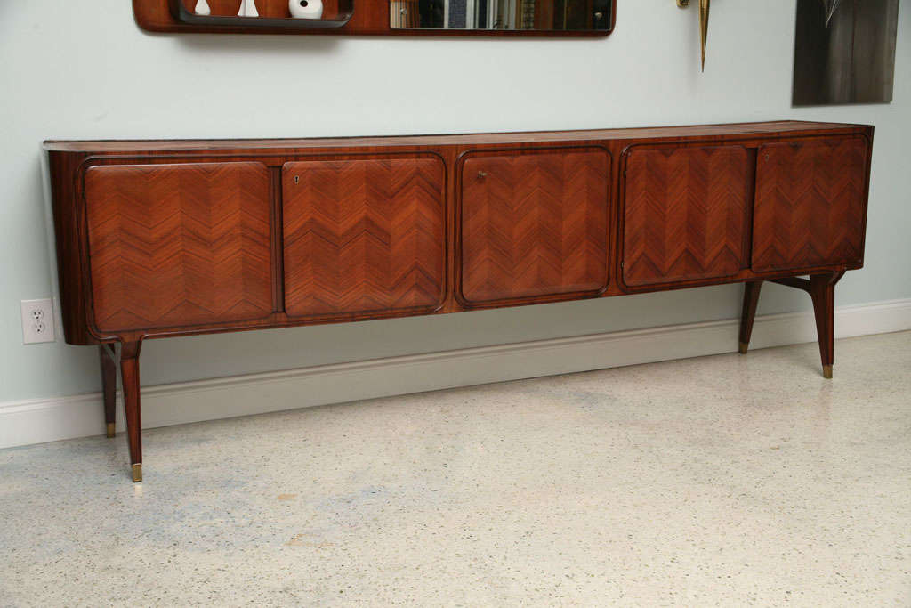 the inset glass top above 5 cabinet doors finely inlaid in herringbone patterns, with fitted interiors