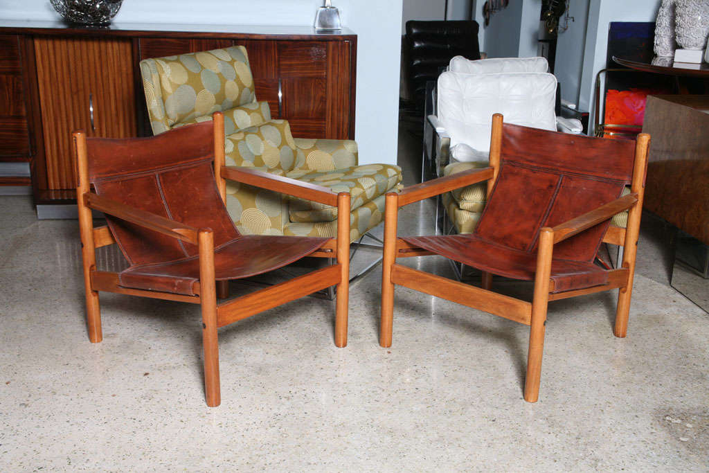 The leather back and seats within a teak frame.