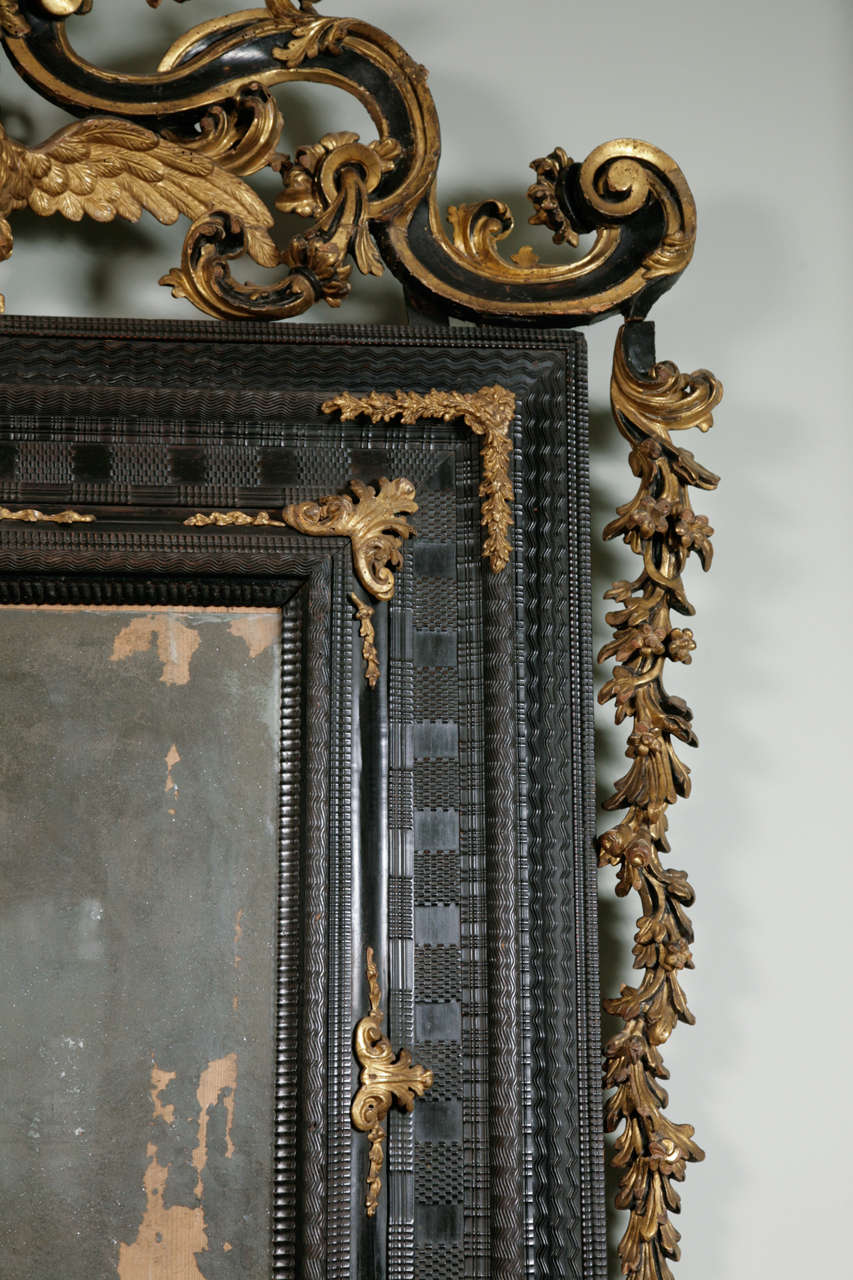 Italian An Early 18th Century Venetian Ebonised & Parcel Gilt Mirror.
