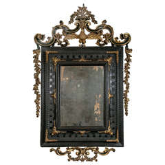 An Early 18th Century Venetian Ebonised & Parcel Gilt Mirror.